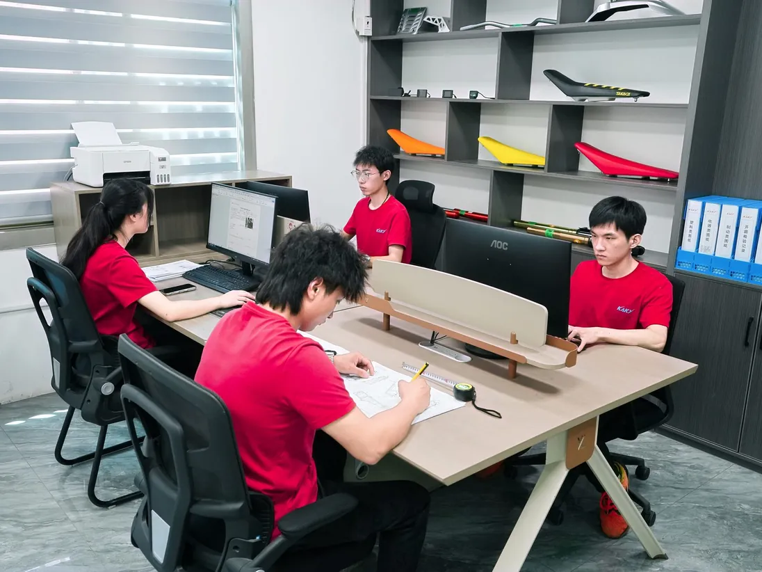 ARKAMOTO engineers measuring and marking up drawings at the design office in Jinhua
