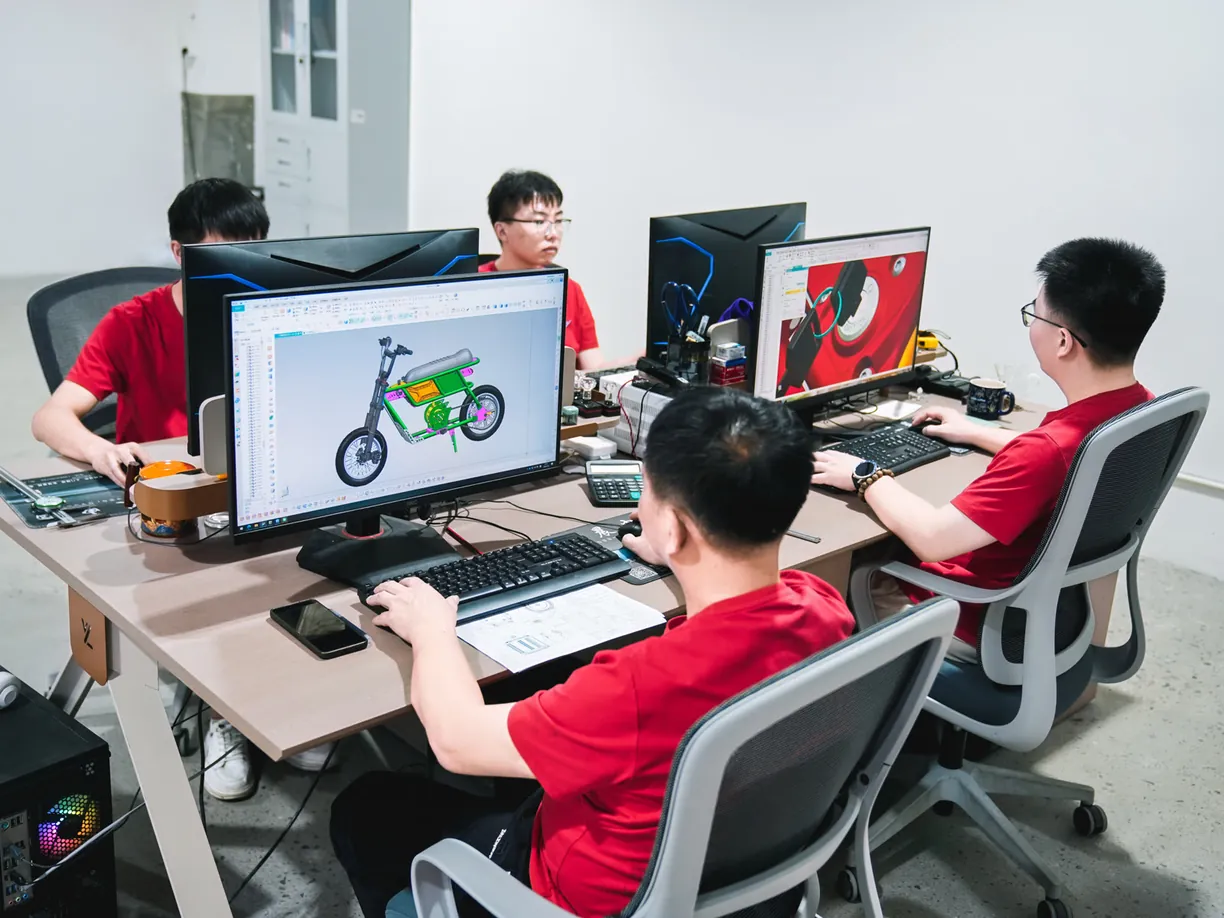 ARKAMOTO engineers working on a motorcycle CAD design