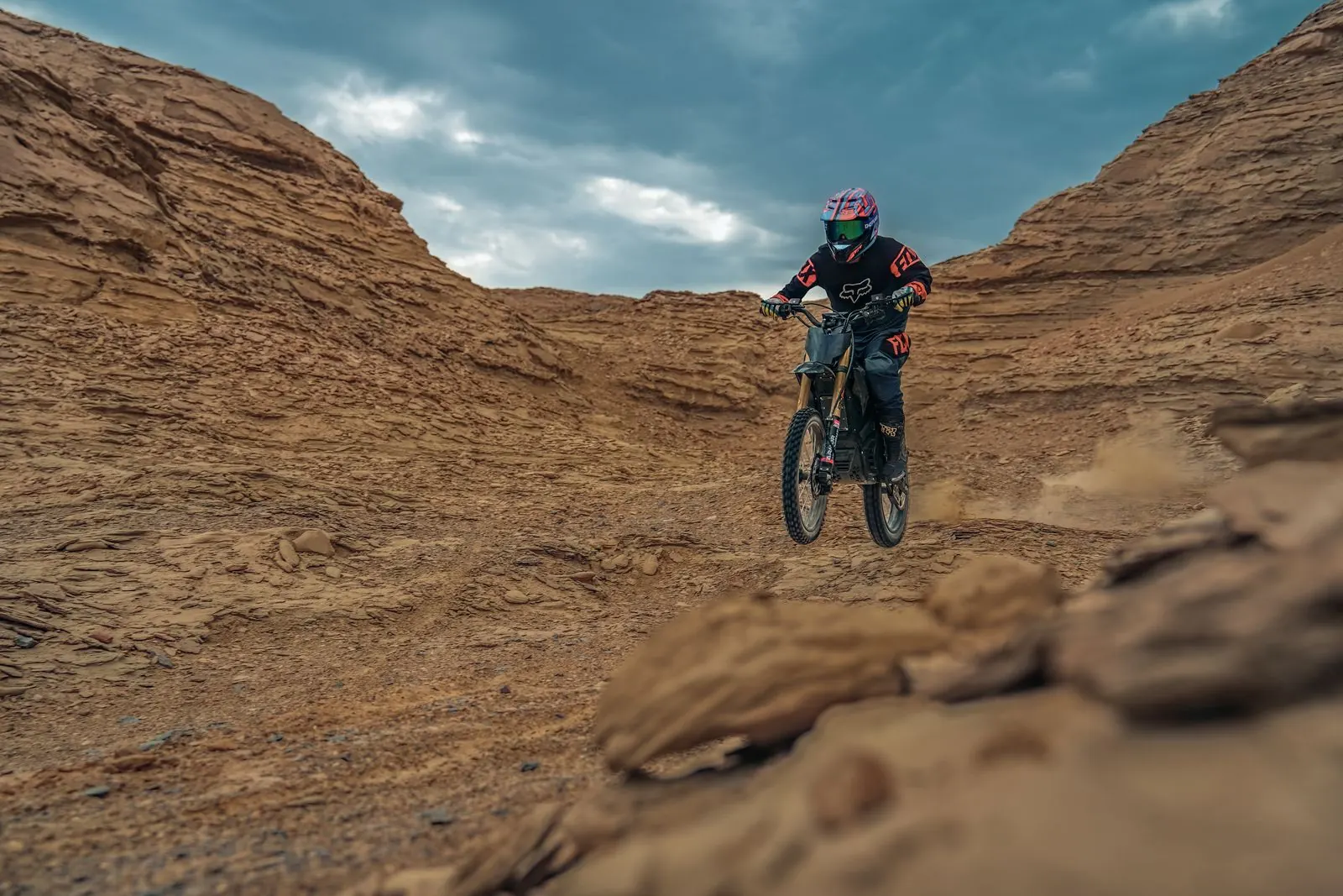 An electric dirt bike ridden on a trail, shot as marketing content